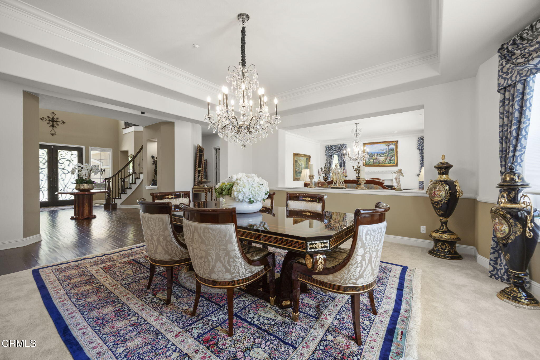 12390 Nelson Road Moorpark, CA 93021 - Photo 8 of 66 a view of a dining room and livingroom with furniture wooden floor a chandelier and a rug