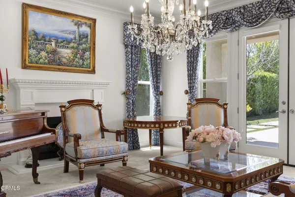 a living room with furniture a fireplace and a large window