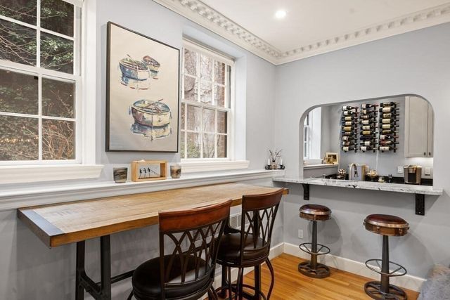 a view of roof deck with seating space and wooden floor