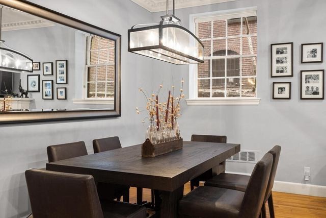 a kitchen with stainless steel appliances granite countertop a sink a stove and a wooden floors