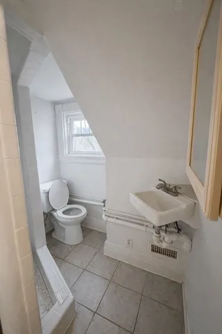 a bathroom with a sink a toilet and mirror