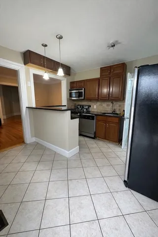 a kitchen with stainless steel appliances granite countertop a sink and a stove top oven with granite countertops