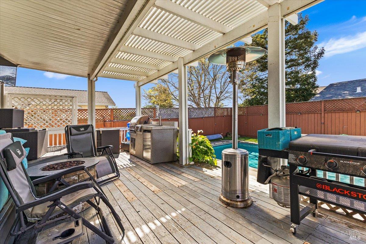 4457 Graywhaler Lane Rohnert Park, CA 94928 - Photo 35 of 51 a view of a patio with table and chairs barbeque with wooden floor and fence