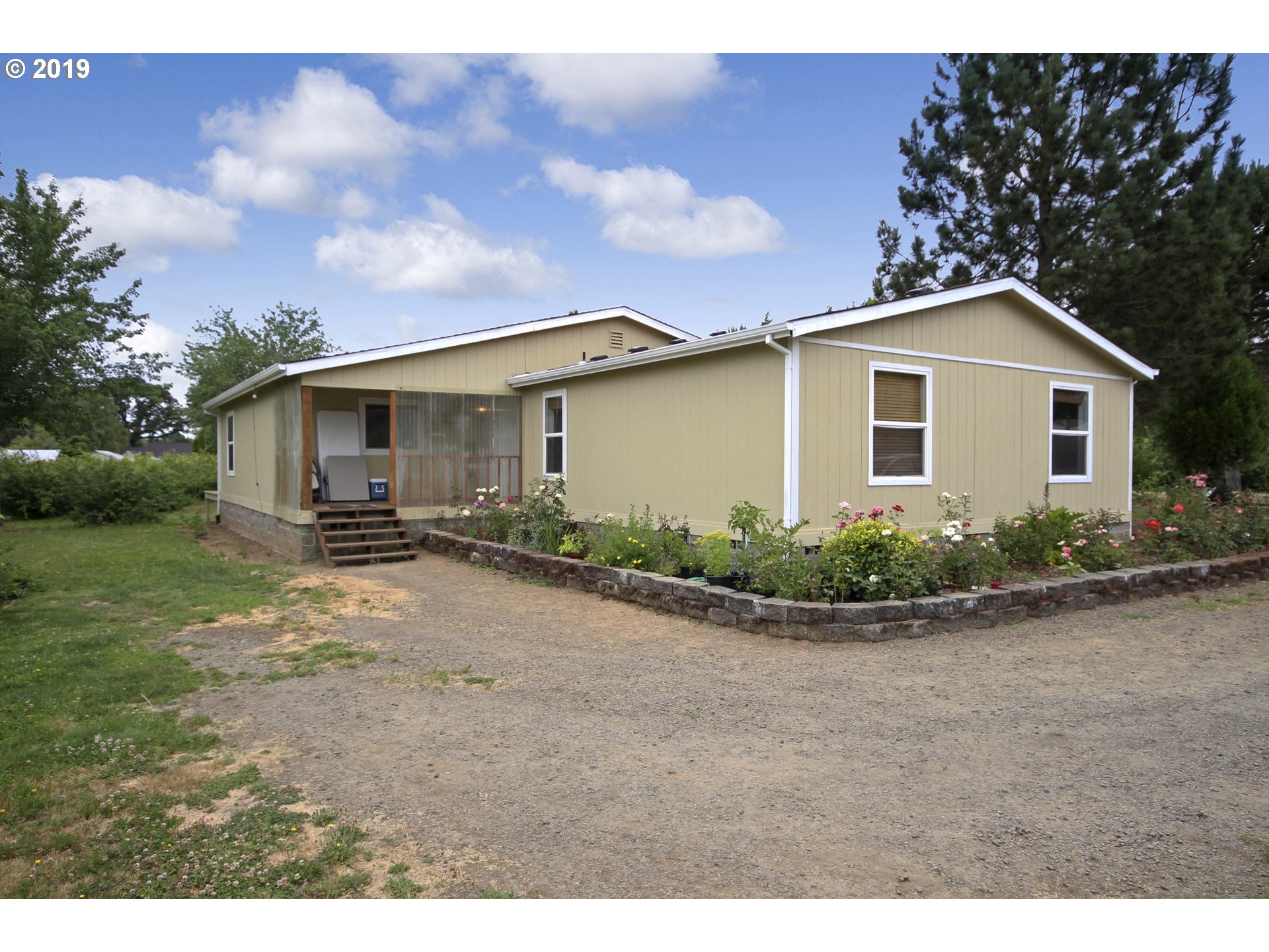 11275 Southwest Spring Hill Road Gaston, OR 97119 - Photo 1 of 17 a front view of a house with garden
