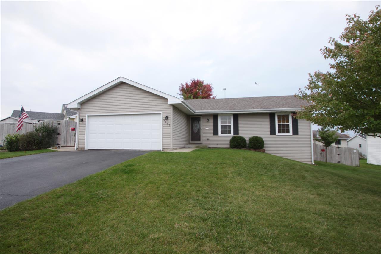 5467 Torque Road Loves Park, IL 61111 - Photo 1 of 21 a front view of a house with a yard and garage