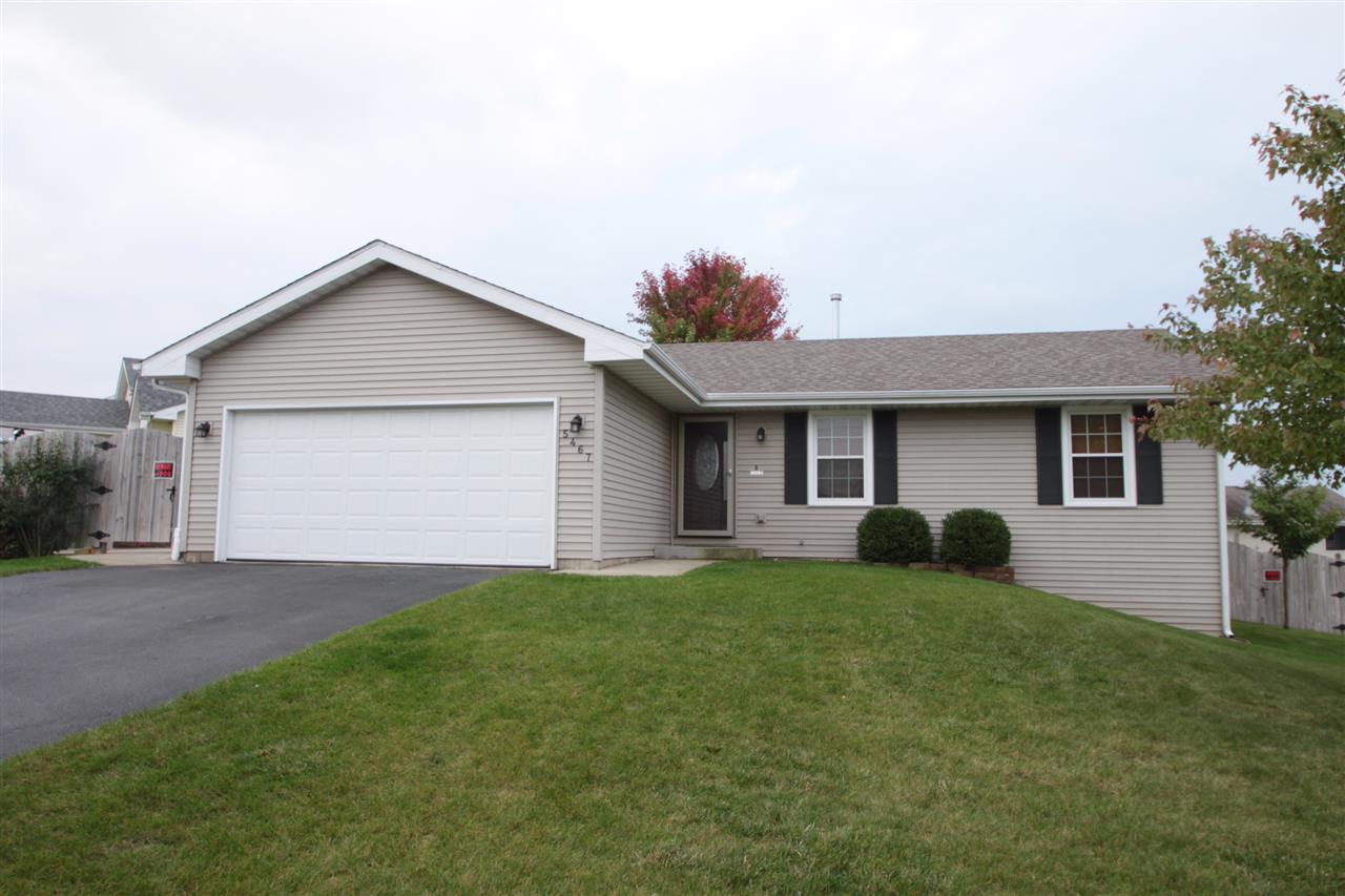 5467 Torque Road Loves Park, IL 61111 - Photo 21 of 21 a front view of a house with a garden and yard