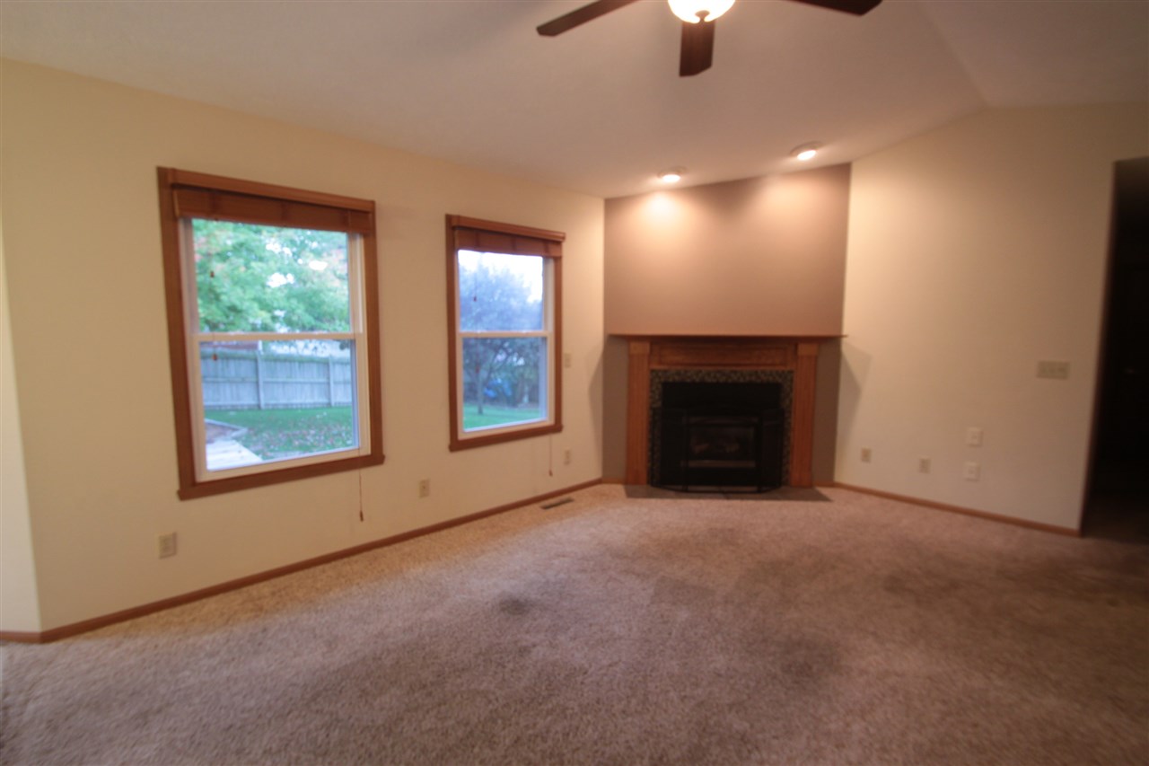 5467 Torque Road Loves Park, IL 61111 - Photo 3 of 21 an empty room with windows and fireplace