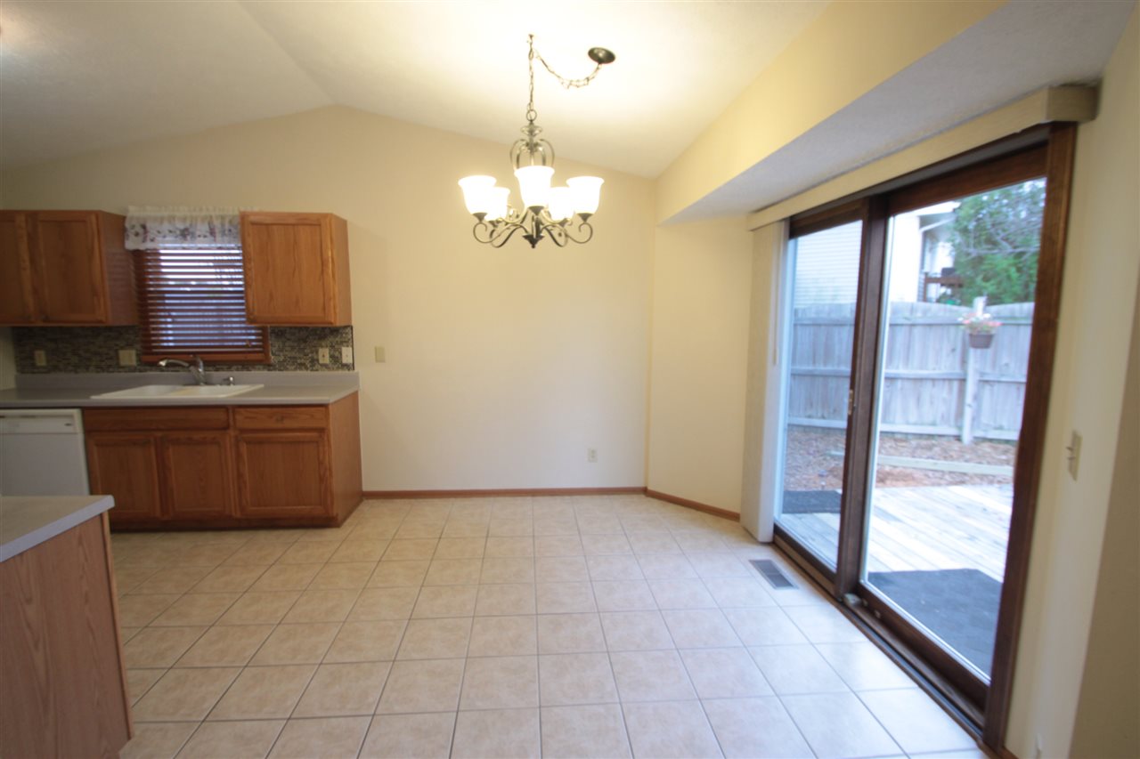 5467 Torque Road Loves Park, IL 61111 - Photo 4 of 21 a kitchen with stainless steel appliances granite countertop a stove a sink and a refrigerator
