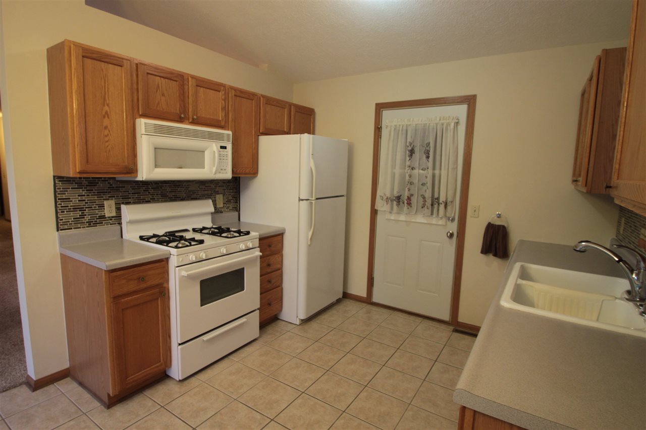 5467 Torque Road Loves Park, IL 61111 - Photo 7 of 21 a kitchen with a refrigerator stove and sink