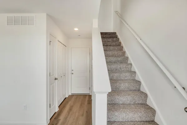a view of staircase with white walls