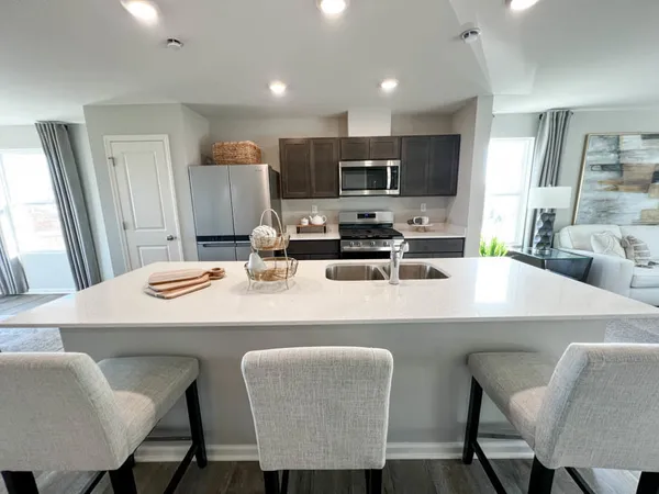 a large kitchen with a table and chairs