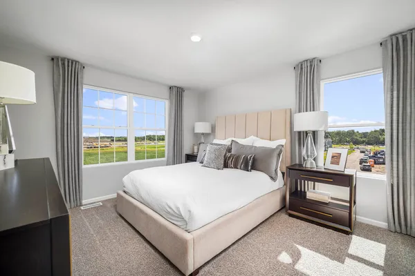 a spacious bedroom with a bed and a large window