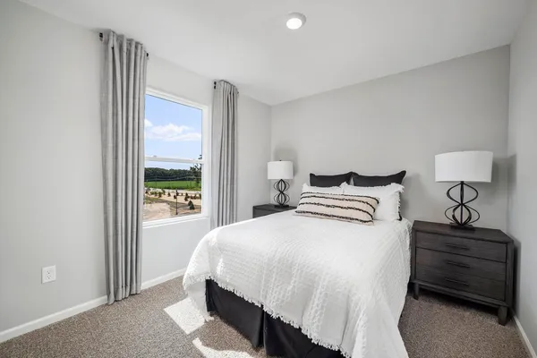 a bedroom with a bed a couch and dresser