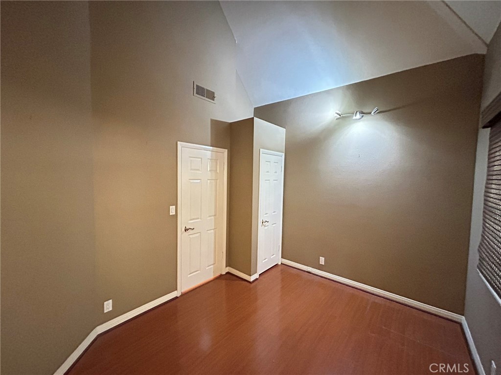 300 South Timken Road Anaheim, CA 92808 - Photo 28 of 40 an empty room with wooden floor and windows