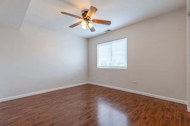 a view of a room with wooden floor and a window