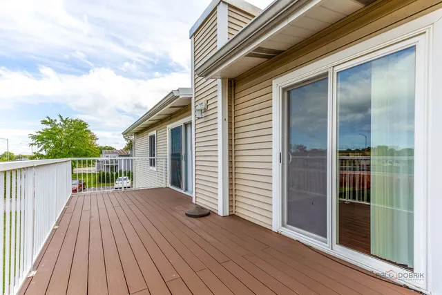 an entrance view with wooden deck