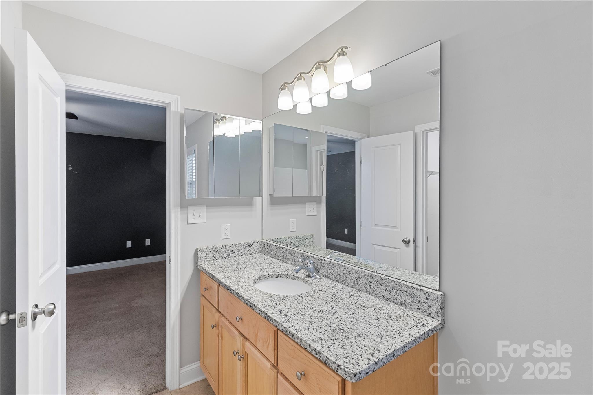 758 Main Street Southwest Concord, NC 28027 - Photo 15 of 25 a bathroom with a granite countertop sink and a mirror