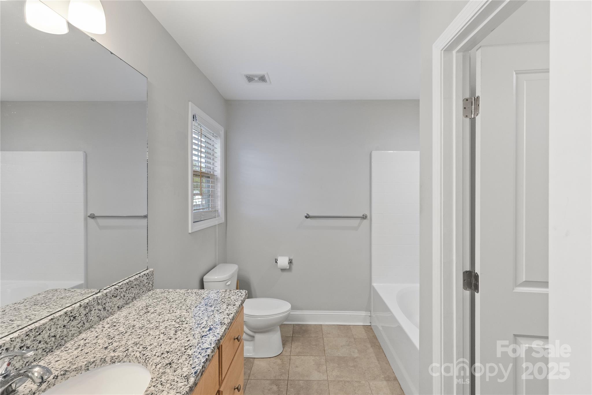 758 Main Street Southwest Concord, NC 28027 - Photo 16 of 25 a bathroom with a granite countertop sink and a toilet