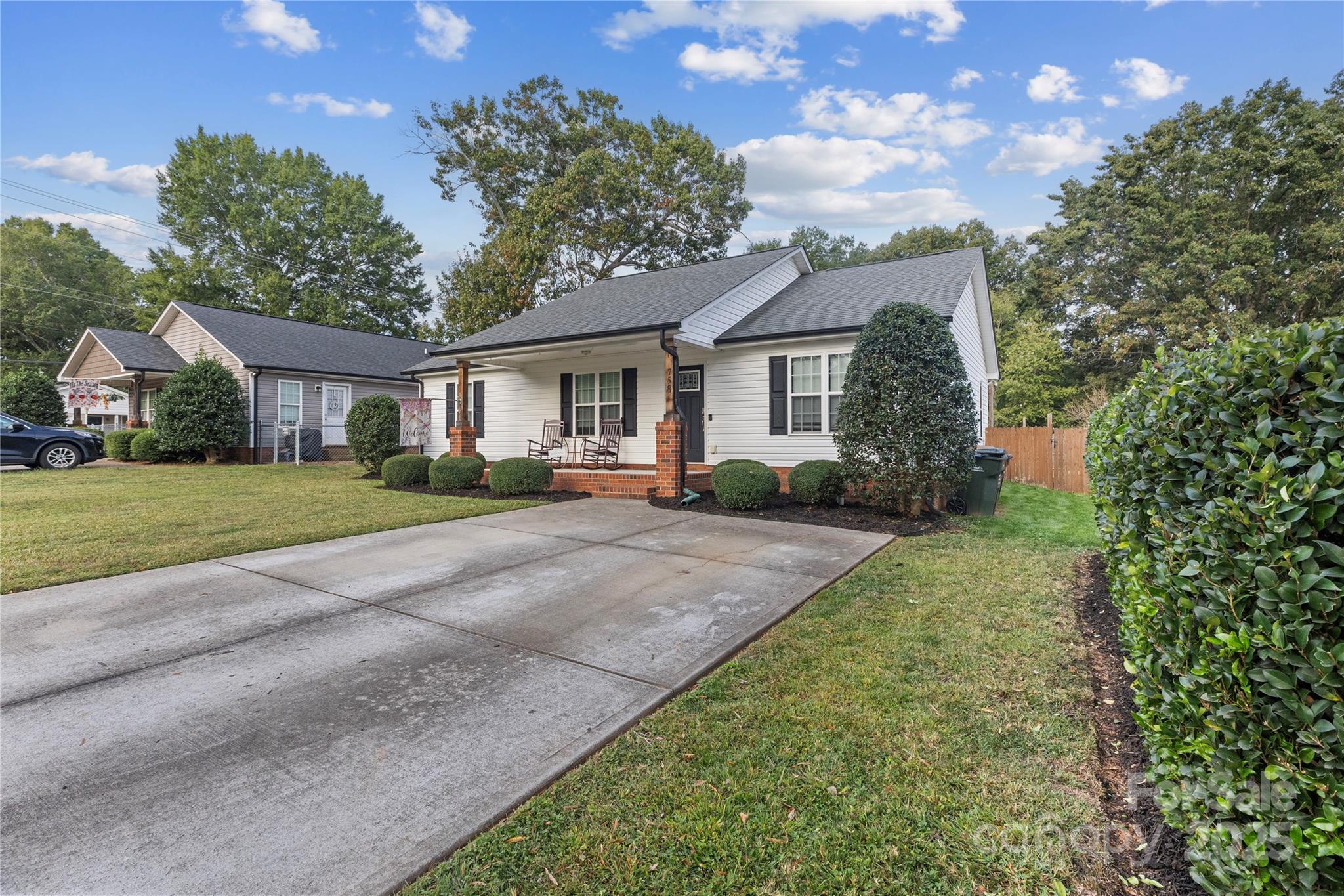 758 Main Street Southwest Concord, NC 28027 - Photo 3 of 25 a front view of a house with a yard and trees