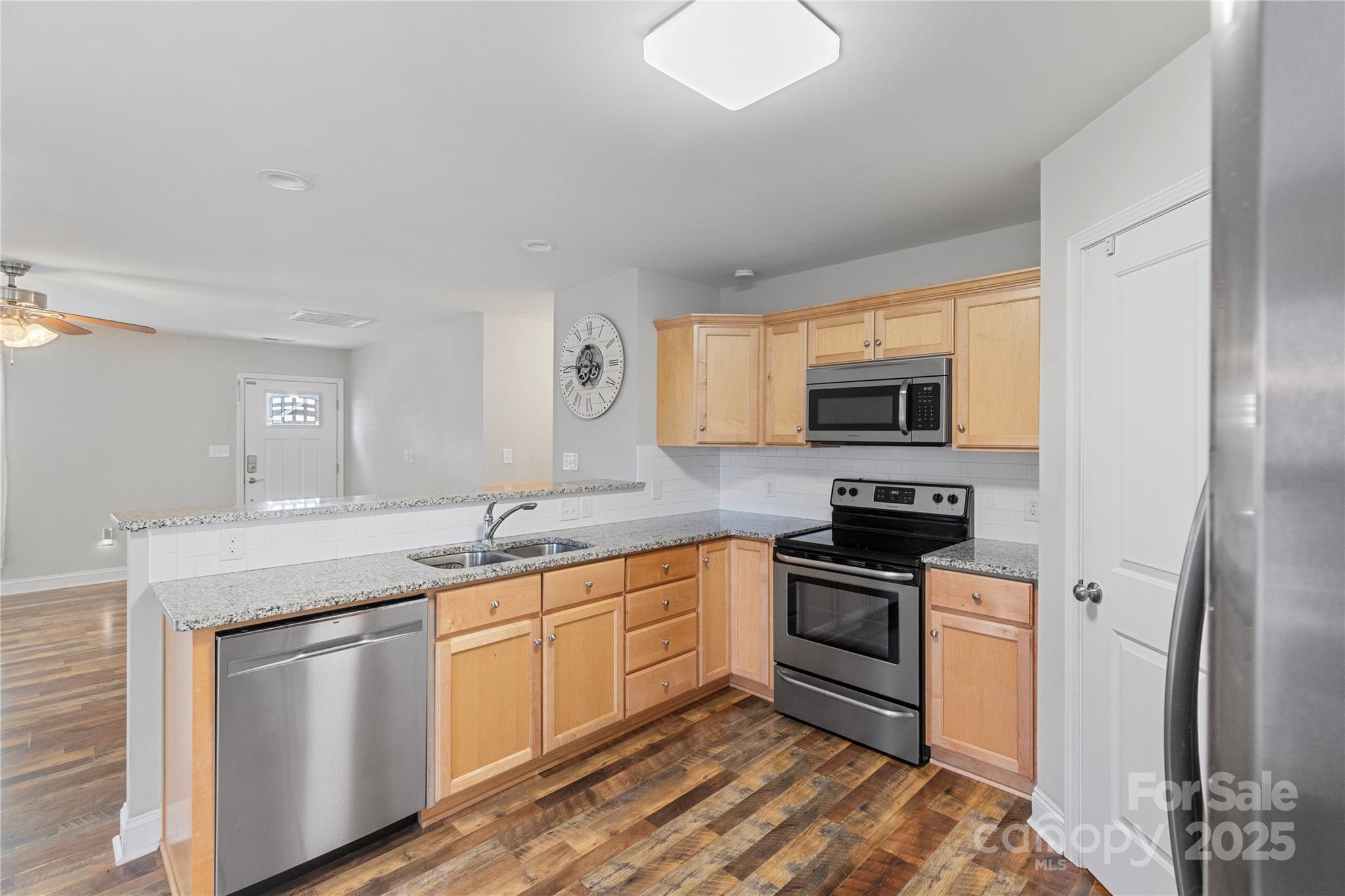 758 Main Street Southwest Concord, NC 28027 - Photo 8 of 25 a kitchen with stainless steel appliances granite countertop a stove a sink and a microwave