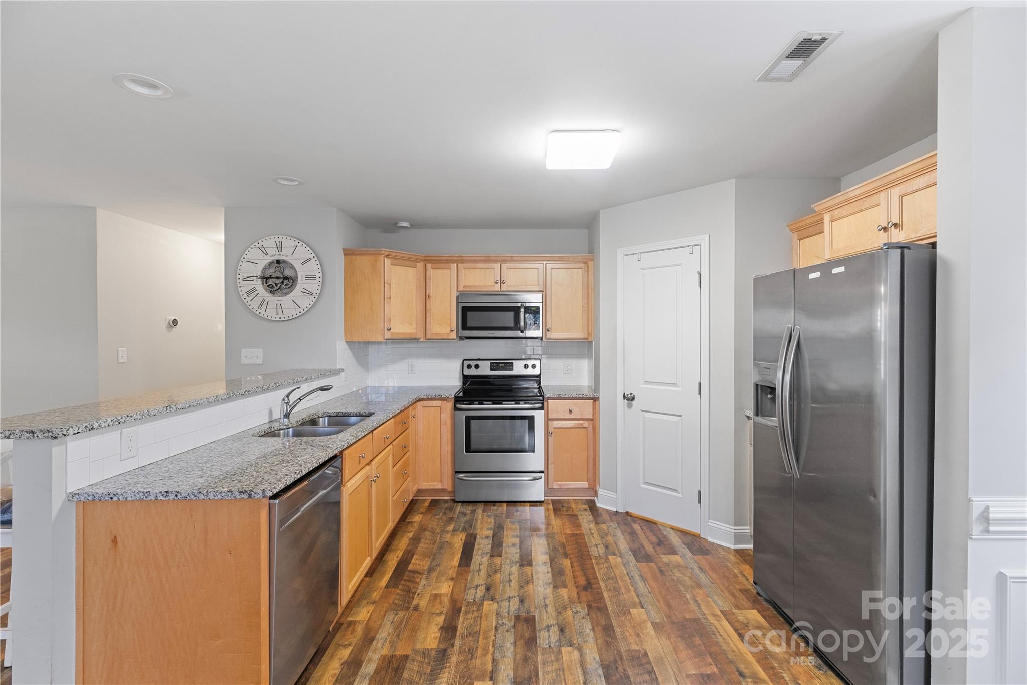 758 Main Street Southwest Concord, NC 28027 - Photo 9 of 25 a kitchen with stainless steel appliances granite countertop a refrigerator a stove and a sink