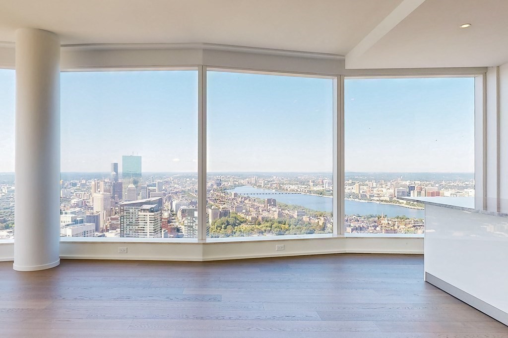 a view of a room with wooden floor and a window