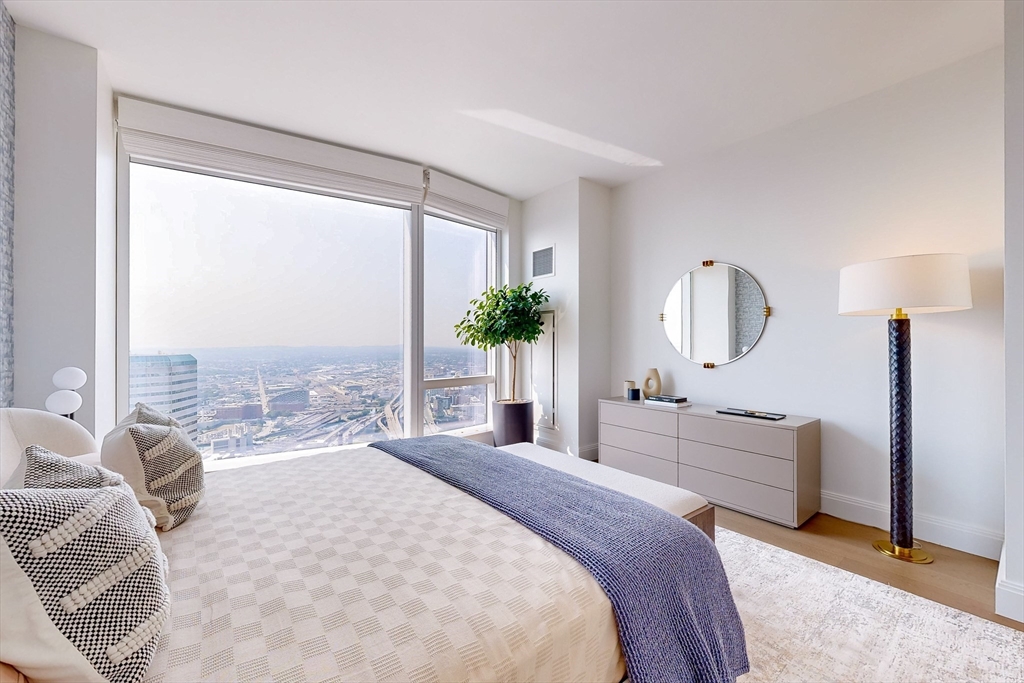 240 Devonshire Street, Unit 4706 Boston, MA 02110 - Photo 8 of 40 a bedroom with a large bed and a large window
