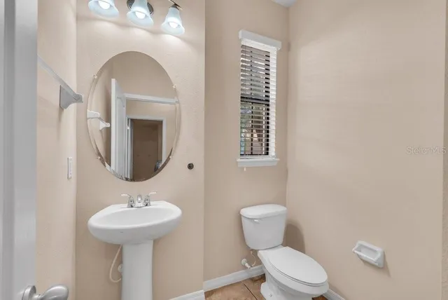 an empty room with windows and ceiling fan