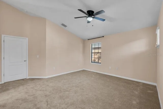 a bathroom with a granite countertop bathtub a sink and a large mirror