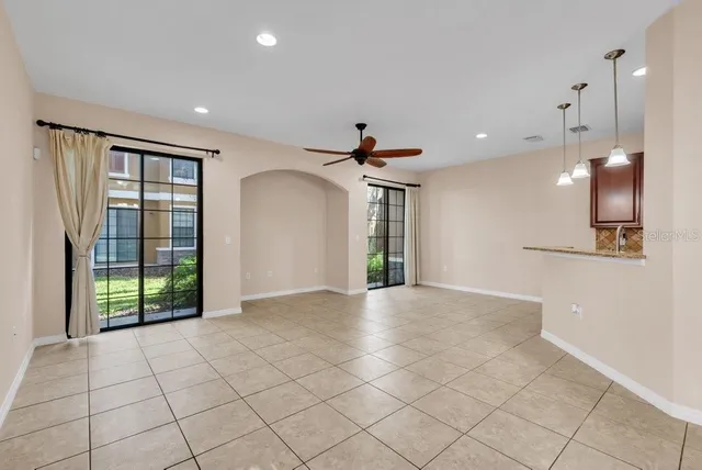 a view of a kitchen with a sink and a refrigerator