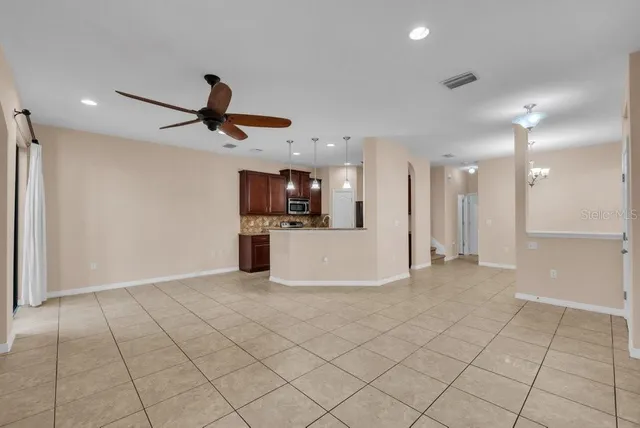 a view of kitchen with stainless steel appliances kitchen island granite countertop a refrigerator and a stove top oven