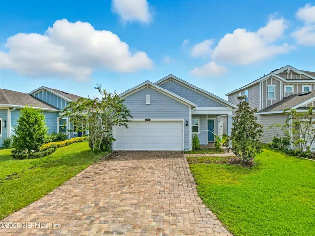 a front view of house with yard and green space