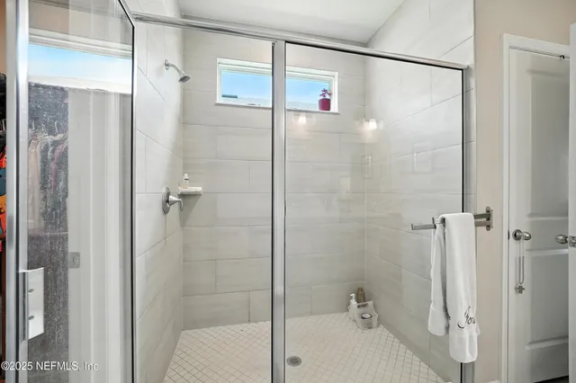 a bedroom with a bed a window and a couch