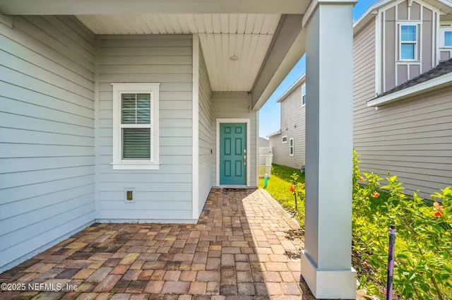 a view of a hallway with a window and a mirror