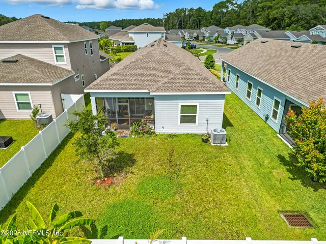 an aerial view of a house with a swimming pool