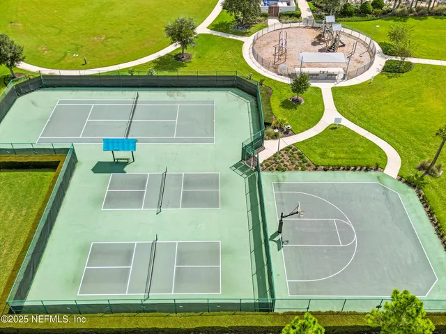an aerial view of a swimming pool with outdoor seating and yard