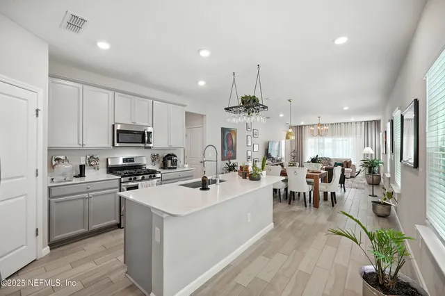 a kitchen that has a sink and a stove top oven