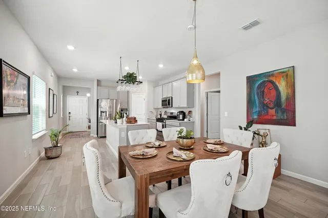 a living room with furniture a flat screen tv and a large window