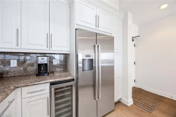 a kitchen with granite countertop stainless steel appliances and refrigerator