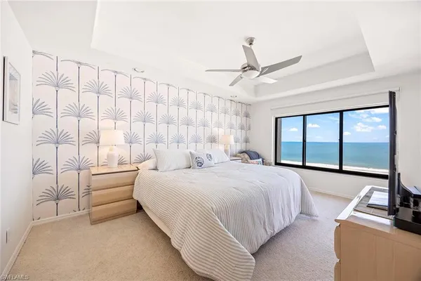 a bedroom with a large bed and a large window