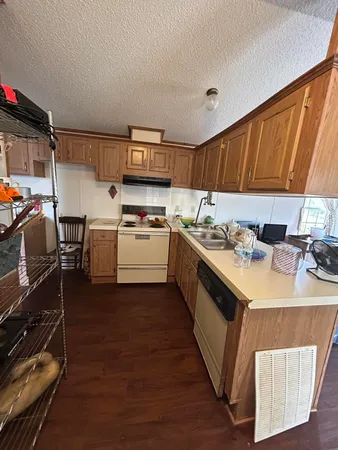 a kitchen with a sink appliances and cabinets