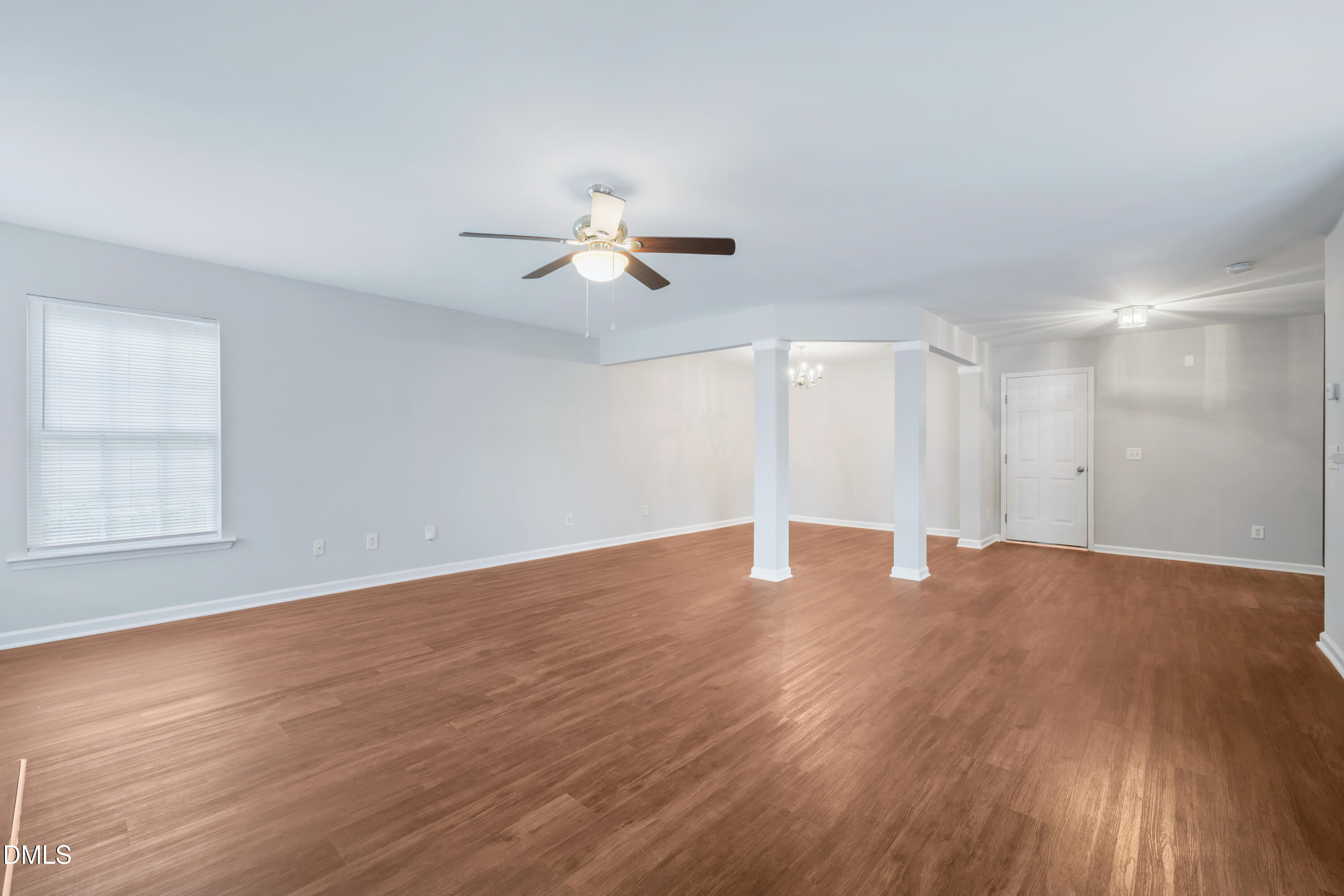 1532 Pebble Ridge Drive Raleigh, NC 27610 - Photo 14 of 40 a view of an empty room with wooden floor and a ceiling fan