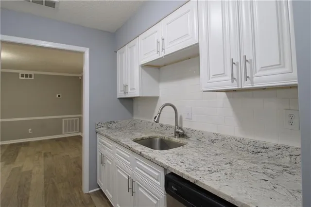 a kitchen with a sink and cabinets