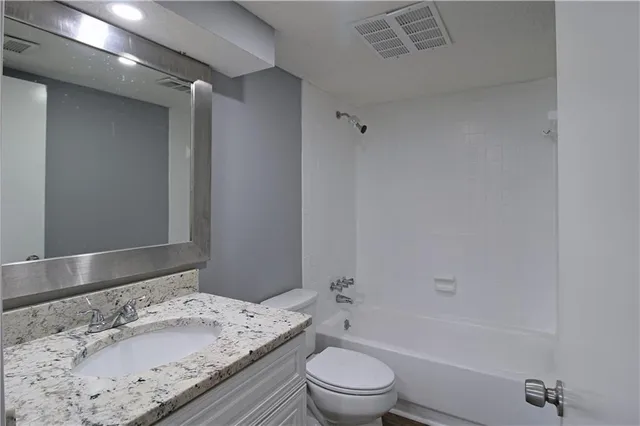 a bathroom with a sink a toilet and bathtub