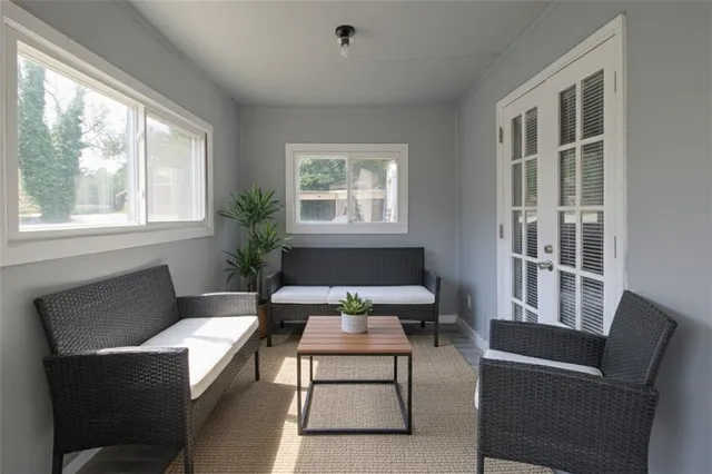 a living room with furniture a rug and a window