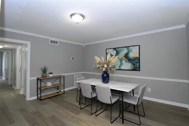 a view of a dining room with furniture and wooden floor