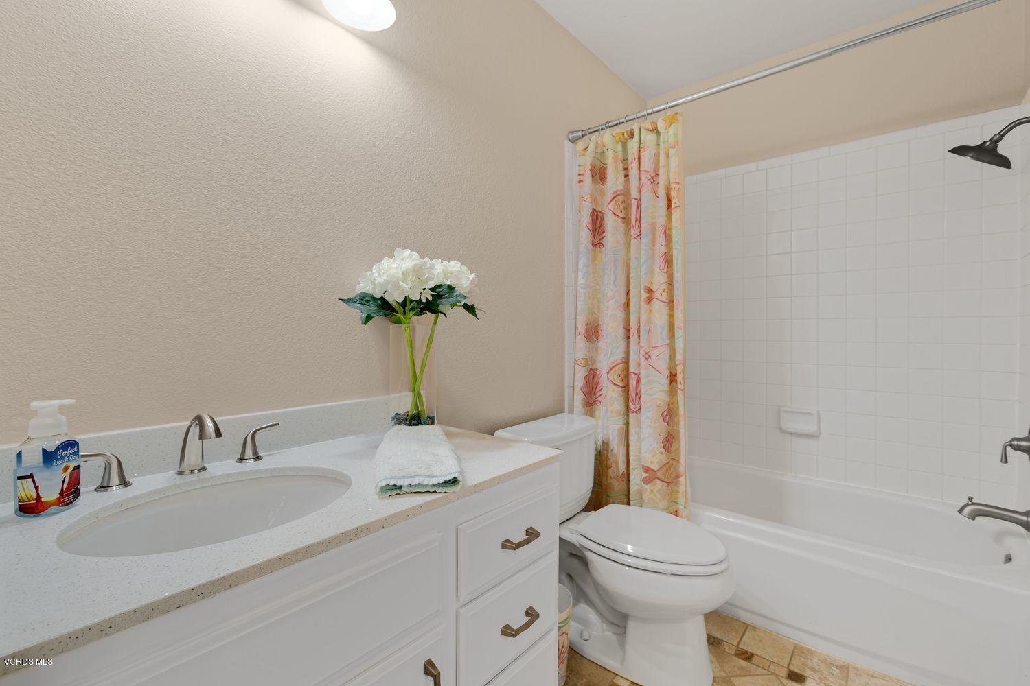 3736 Via Pacifica Walk Oxnard, CA 93035 - Photo 14 of 20 a bathroom with a sink a toilet and shower