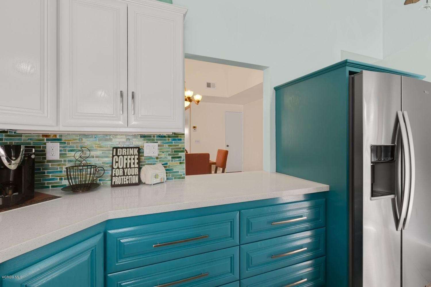 3736 Via Pacifica Walk Oxnard, CA 93035 - Photo 6 of 20 a kitchen with a refrigerator and cabinets