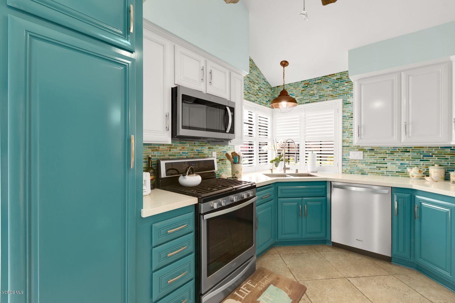 3736 Via Pacifica Walk Oxnard, CA 93035 - Photo 8 of 20 a kitchen with granite countertop cabinets stainless steel appliances and a window