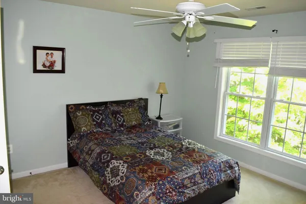 a bed sitting in a bedroom next to a window